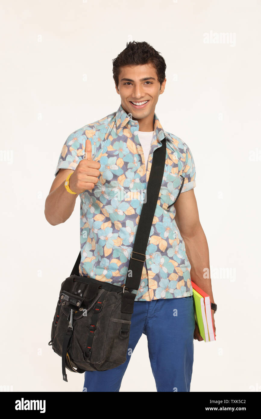 College student with a bag and showing thumbs up sign Stock Photo - Alamy