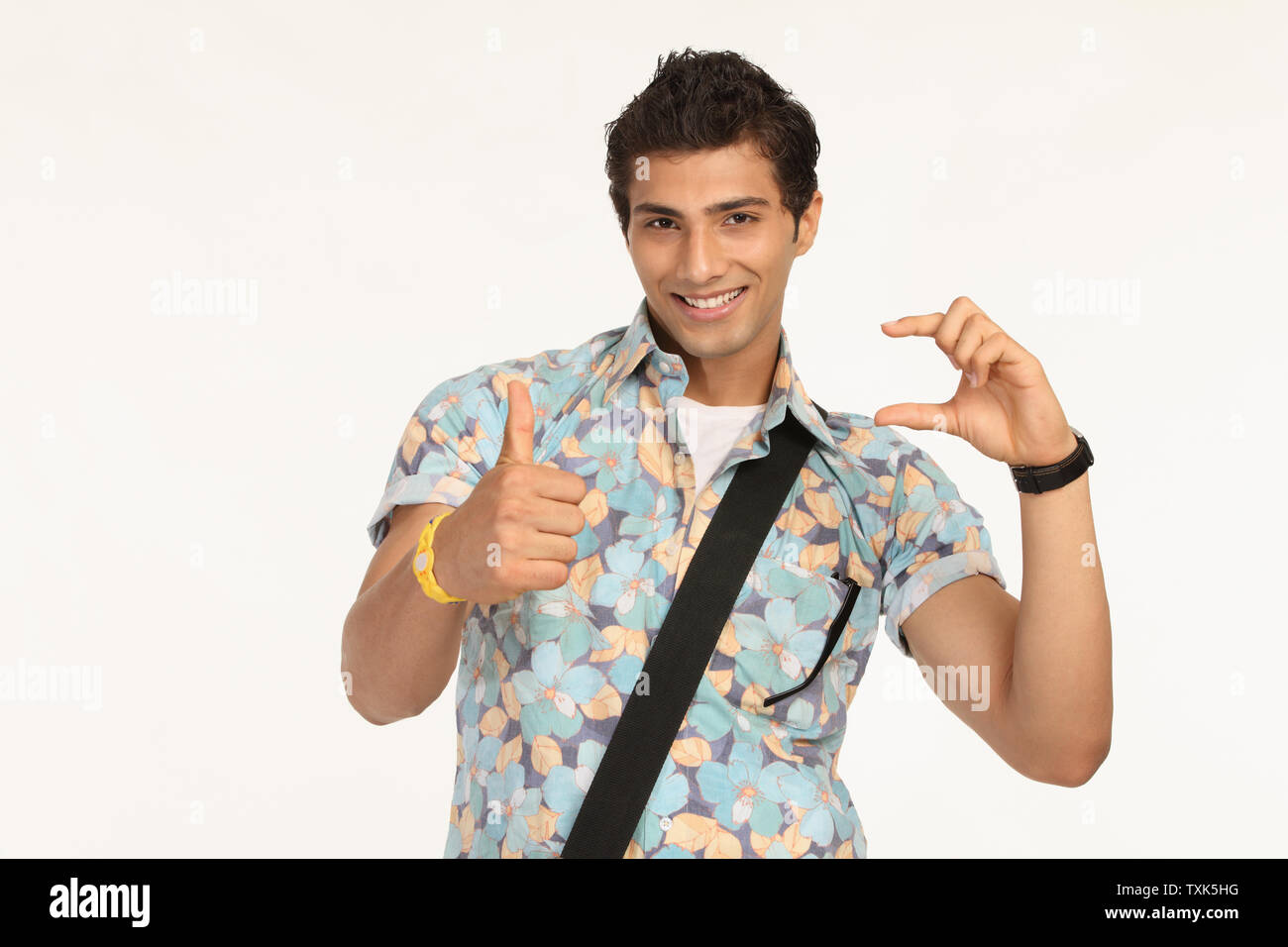 Portrait of a college student showing thumbs up sign Stock Photo - Alamy