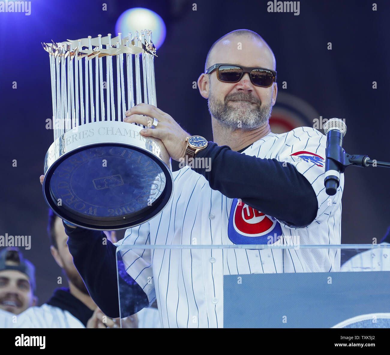 Chicago Cubs' David Ross holds the Commissioner's Trophy during