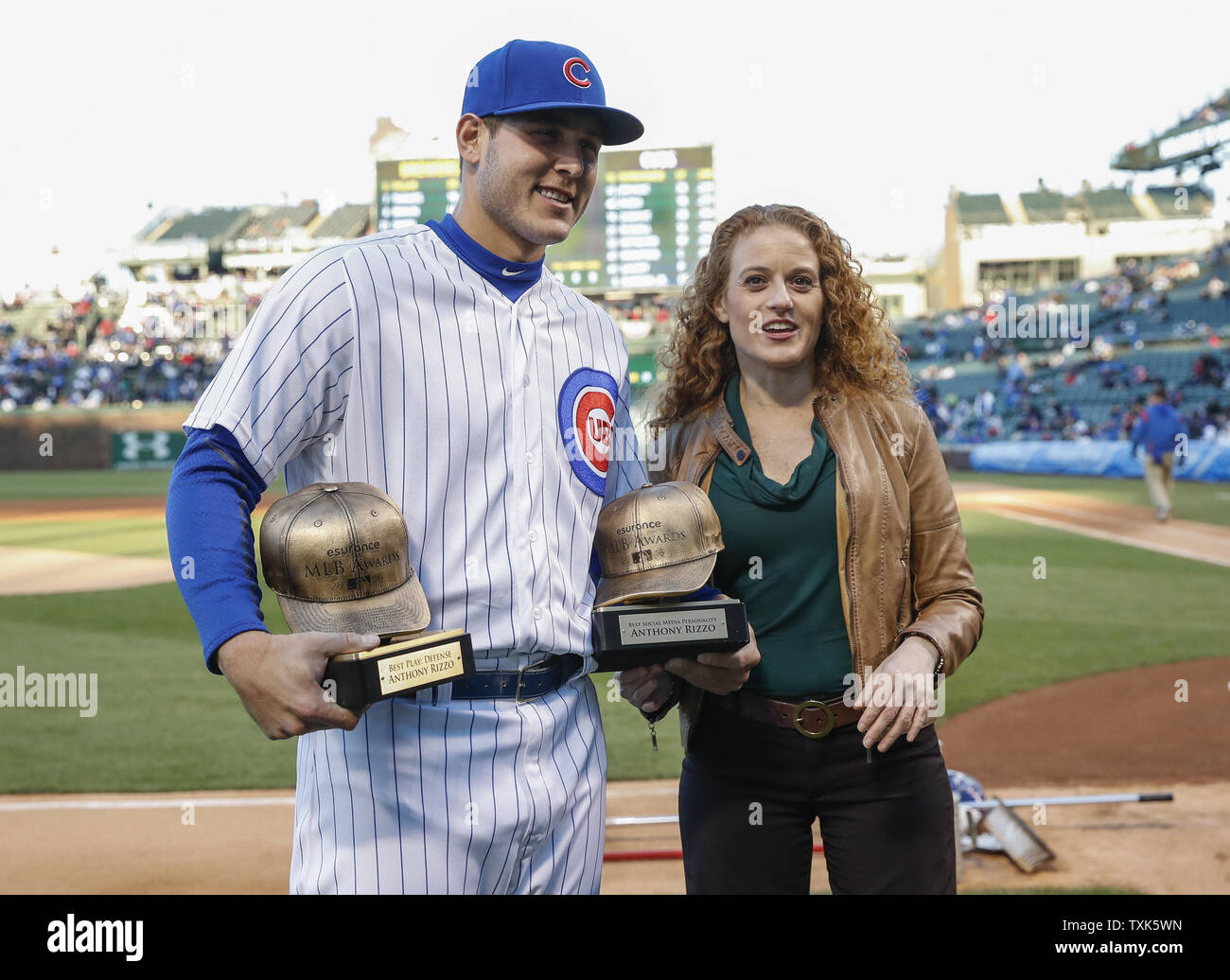 Chicago Cubs first baseman Anthony Rizzo, left, receives a Championship Ring  during a ring ceremony before a baseball game between the Chicago Cubs and  Los Angeles Dodgers at Wrigley Field on April