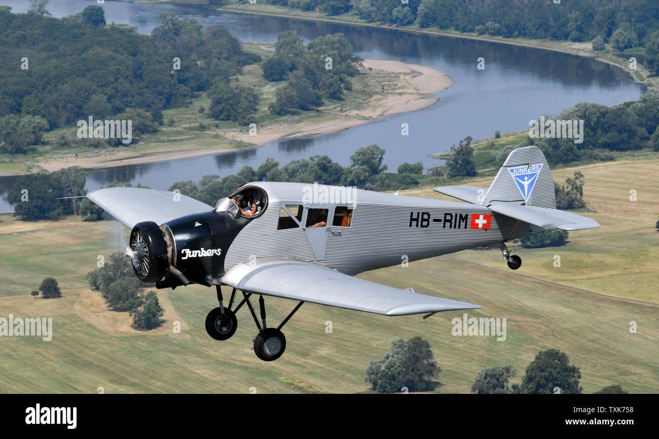 25 June 2019, Saxony-Anhalt, Dessau-Roßlau: The pilots Dieter Morszeck and Kurt Waldmeier steer the Junkers F 13 via Dessau. Exactly 100 years ago, an aircraft of this type took off for the first time in Dessau. The aircraft, designed by aircraft pioneer Hugo Junkers, was the world's first all-metal commercial aircraft and is regarded as a pioneer in civil aviation. Since 2016, the machine has again been manufactured in small series in Switzerland. Photo: Hendrik Schmidt/dpa-Zentralbild/dpa Stock Photo