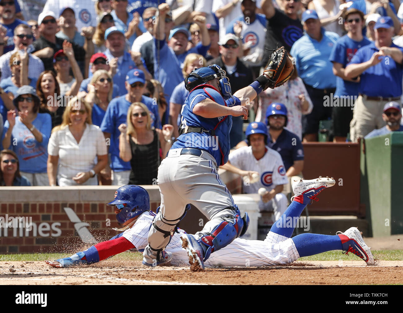 Chicago Cubs Javier Baez back is tagged out at home plate by Toronto Blue Jays Miguel Montero front in the second inning at Wrigley Field on August 18 2017 in Chicago. Photo