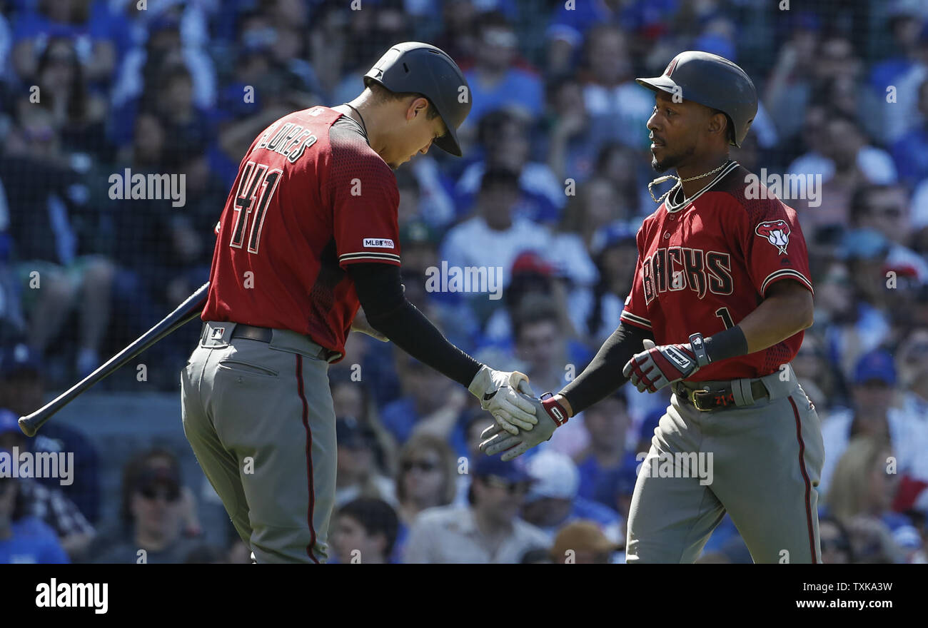 Arizona Diamondbacks' Jarrod Dyson (1) celebrates with Wilmer Flores (41) after hitting a solo home run off of Chicago Cubs' Pedro Strop in the ninth inning at Wrigley Field on April 21, 2019 in Chicago. Photo by Kamil Krzaczynski/UPI Stock Photo