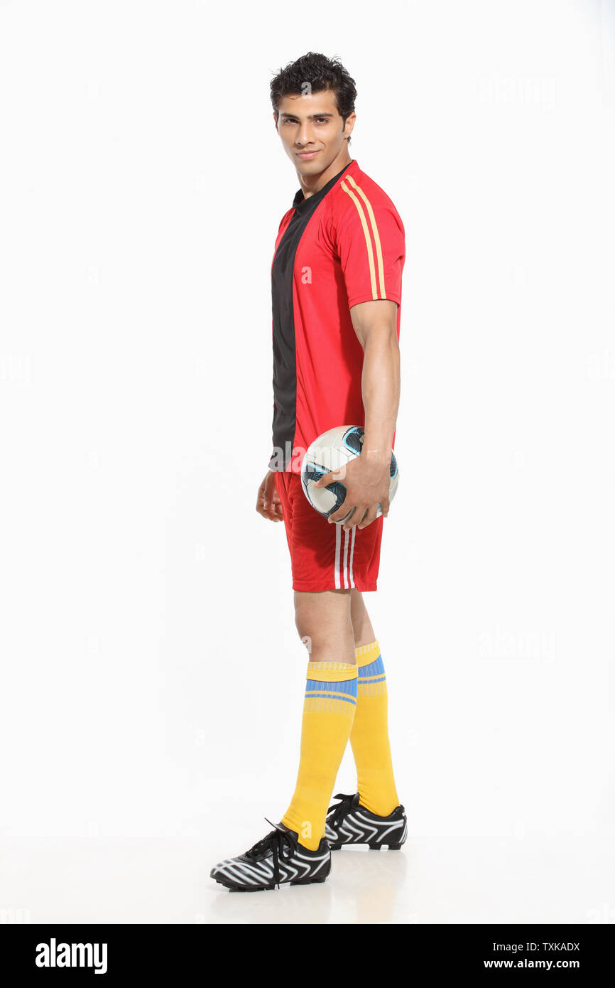 Portrait of a man holding a soccer ball Stock Photo - Alamy