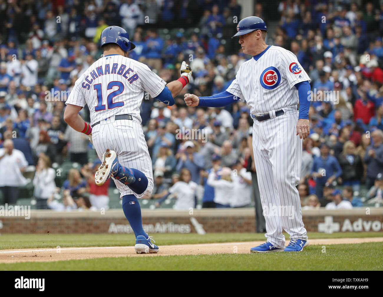 Chicago Cubs' Kyle Schwarber (L) celebrates with third base coach Brian Butterfield (R) after hitting a solo home run against the Cincinnati Reds in the first inning at Wrigley Field on May 24, 2019 in Chicago. Photo by Kamil Krzaczynski/UPI Stock Photo