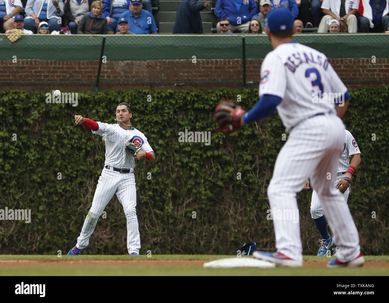 Chicago Cubs' Albert Almora Jr. (L) throws the ball to Daniel Descalso (R) against the Cincinnati Reds in the fourth inning at Wrigley Field on May 24, 2019 in Chicago. Photo by Kamil Krzaczynski/UPI Stock Photo