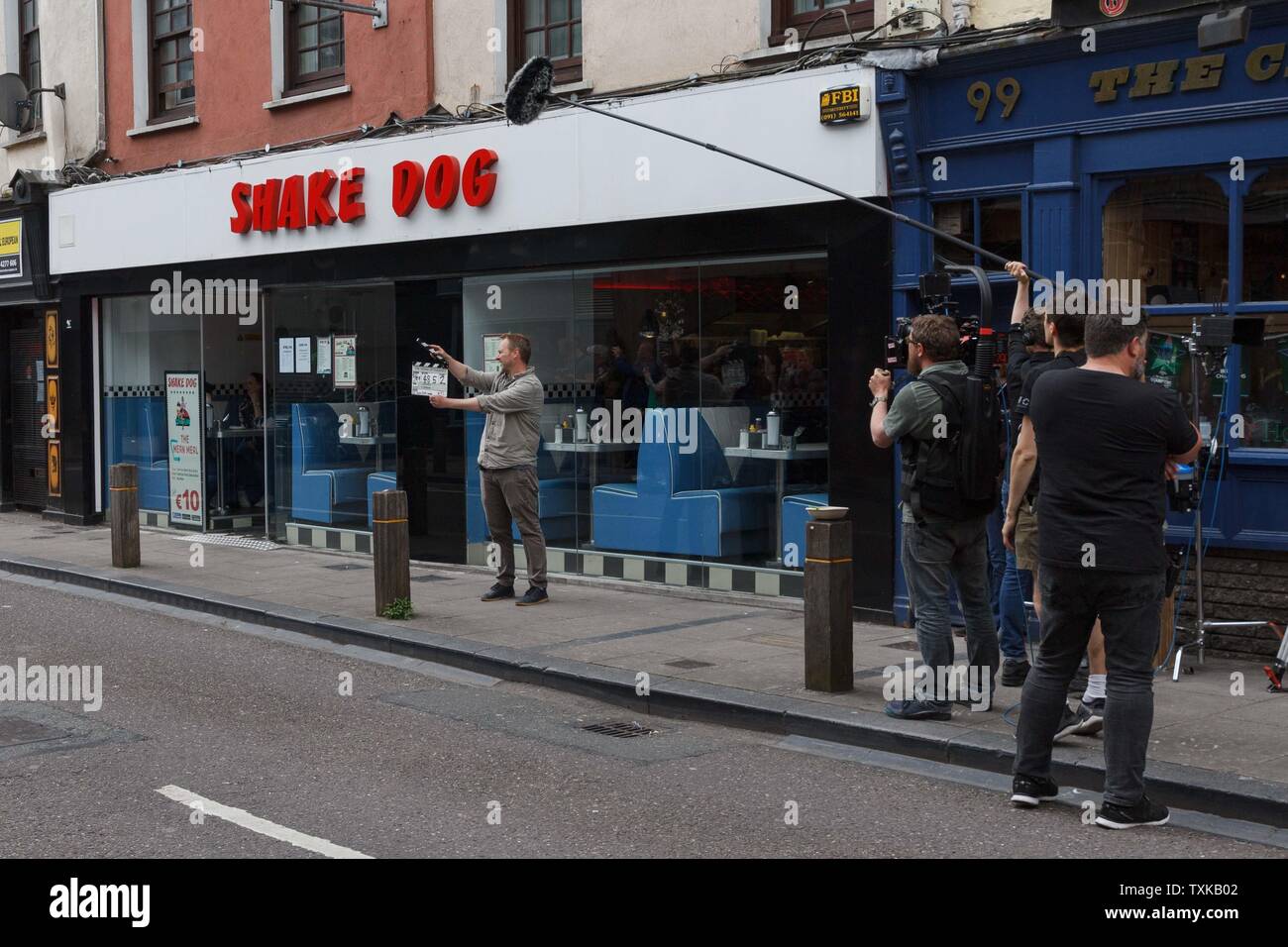 Cork, Ireland, 21st June, 2019.   Young Offenders Filming on North Main Street, Cork City. The Young Offenders were filming again today, this time in the Shakedog diner in North Main Street.   Credit: Damian Coleman. Stock Photo