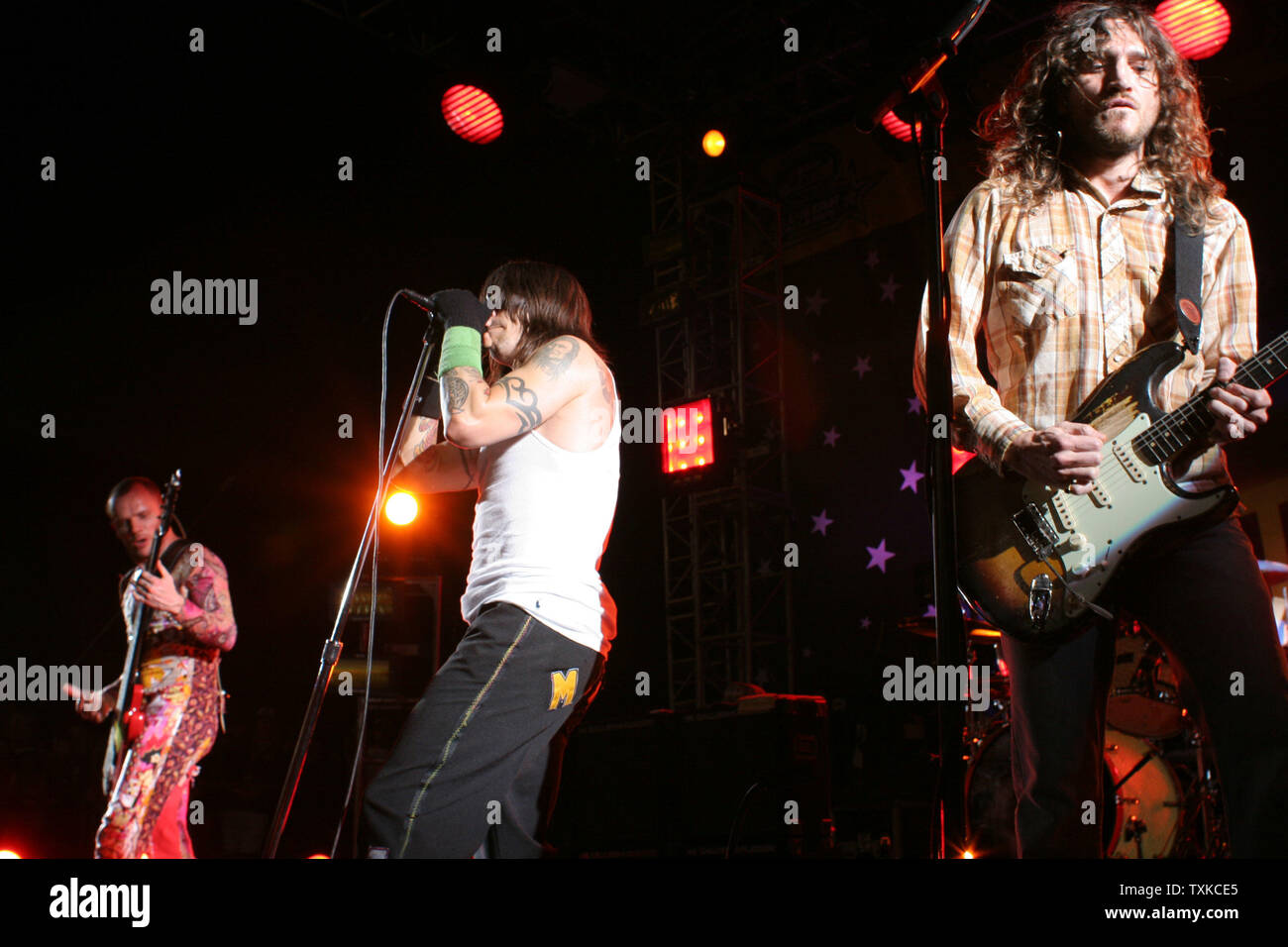 The Red Hot Chili Peppers guitarist Flea (l) lead singer Anthony Kiedis (c) and guitarist John Frusciante (l) perform at the NASCAR NEXTEL Challenge at Lowe's Motor Speedway in Charlotte, NC on May 20, 2006.  (UPI Photo/Bob Carey) Stock Photo
