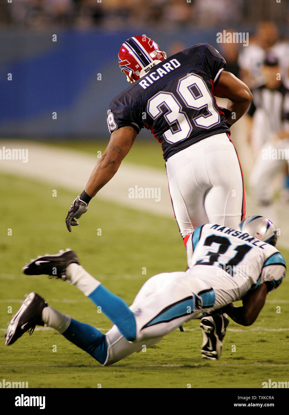 Buffalo Bills full back Alan Ricard is pulled down by Carolina Panther