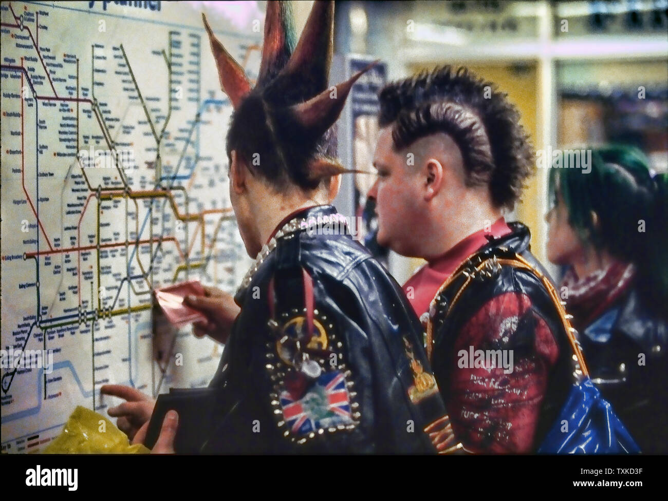 Punks checking tube map in London Underground, England, UK. Stock Photo