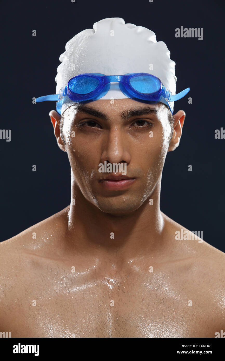 Portrait of a man wearing swimming cap and goggles Stock Photo