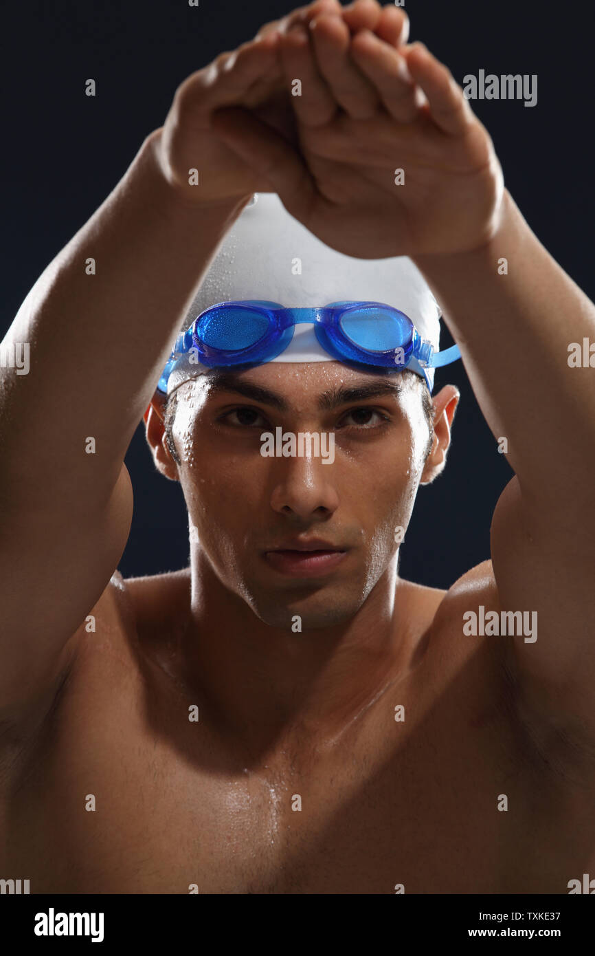 Portrait of a man wearing swimming cap and goggles Stock Photo