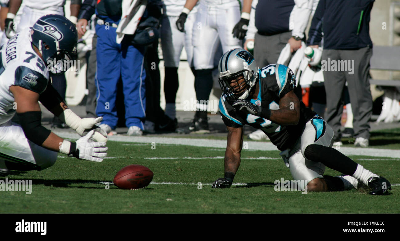 Carolina Panthers cornerback Richard Marshall (31) looks back at a loose ball while Seattle Seahawks guard Sean Locklear (75) dives to recover the fumble in the first quarter at Bank of America Stadium on December 16, 2007 in Charlotte, NC.    (UPI Photo/Bob Carey) Stock Photo