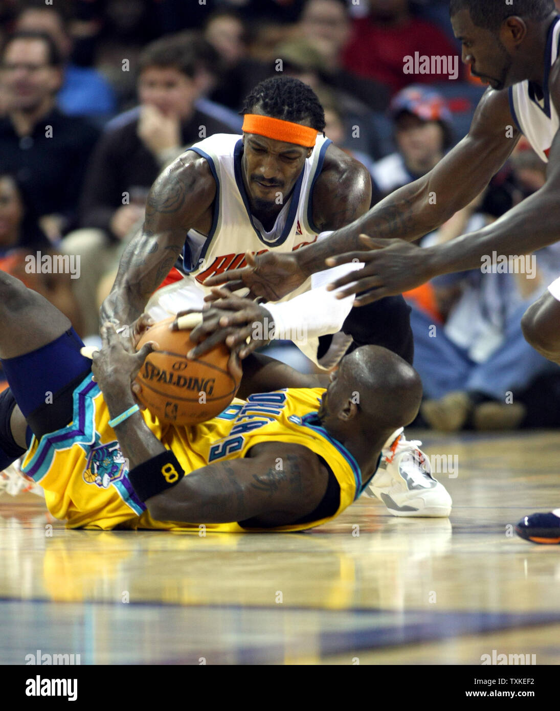 Charlotte Bobcats Guard Gerald Wallace Top And New Orleans Hornets Guard Bobby Jackson 8 Battle For A Loose Ball At The Charlotte Bobcats Arena In Charlotte North Carolina On December 28 07