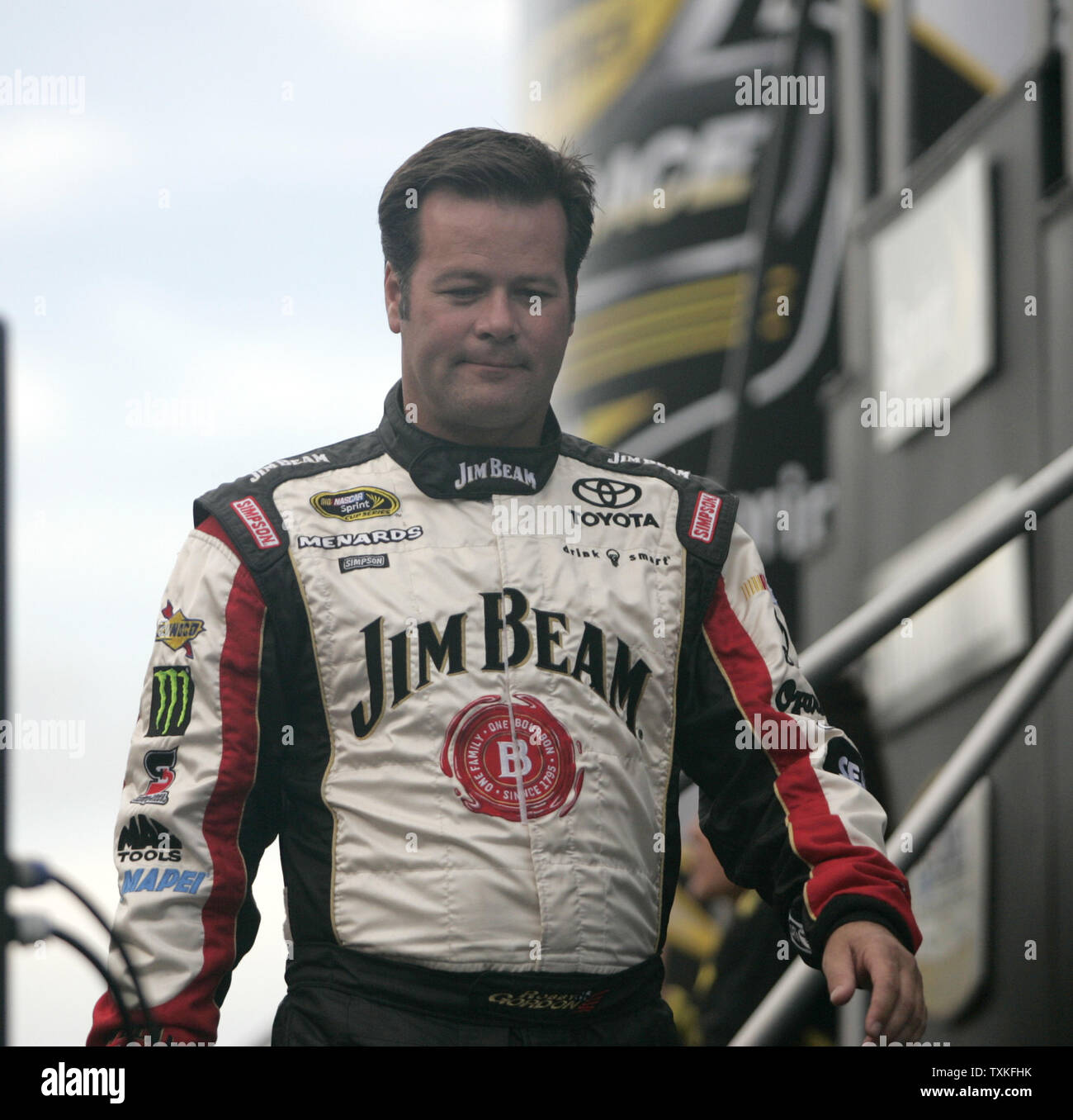 Race car driver Robby Gordon walks across the stage during driver ...