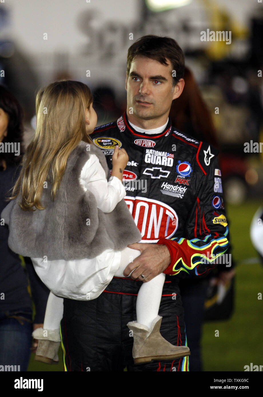 Race car driver Jeff Gordon carries his daughter Ella Sophia Gordon