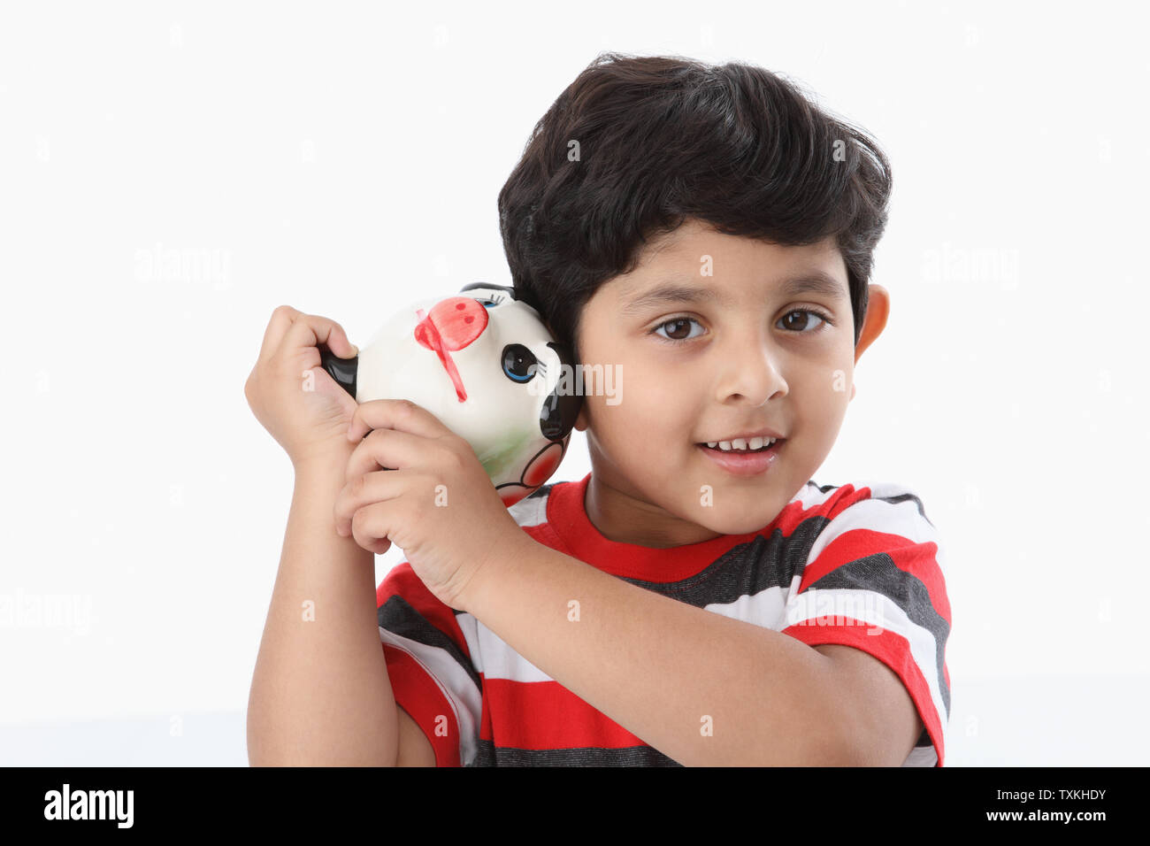 Portrait of a boy holding a piggy bank and smiling Stock Photo - Alamy