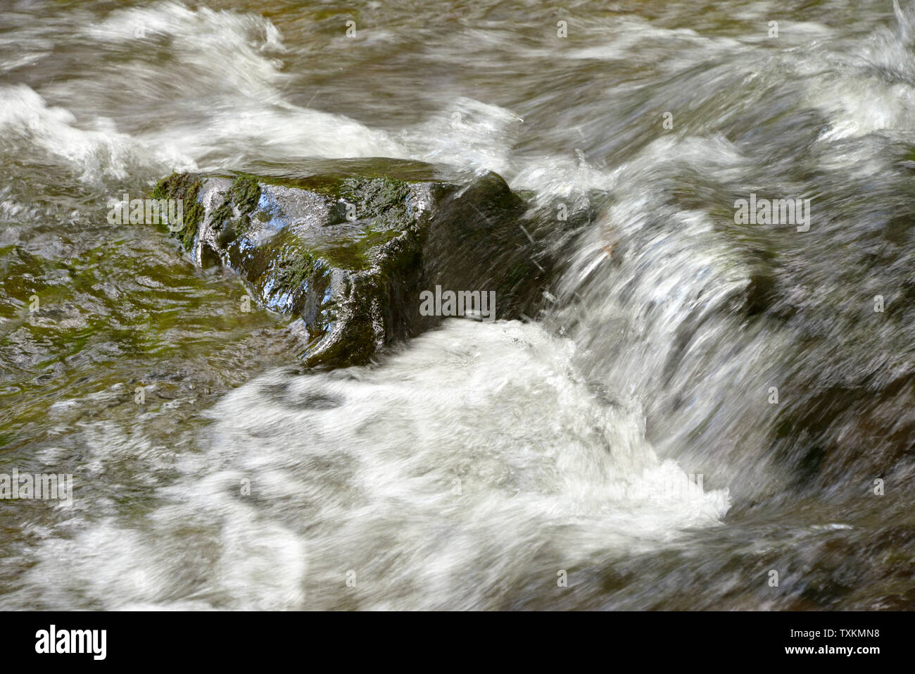 Stream flowing into rocks hi-res stock photography and images - Alamy