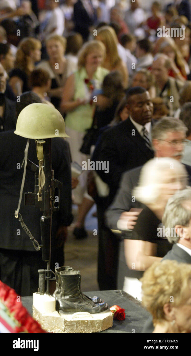 A memorial for fallen soldiers stand at the front-center of the stage as people walk past following the memorial service for the fallen 3rd Battalion, 25th Marines at the International Exposition Center in Cleveland Monday, Aug. 8, 2005.  (UPI Photo/Scott R. Galvin) Stock Photo