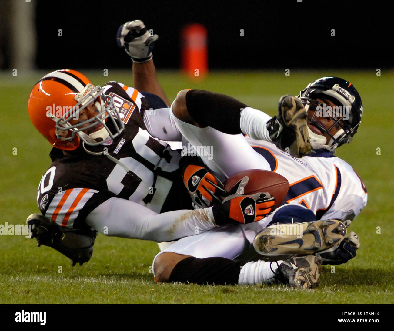 Cleveland Brown defensive back Ralph Brown, 20, and Denver Bronco wide receiver Javon Walker, 84, wrestle over the ball after an incomplete pass on the 45 yard line during the fourth quarter at the Cleveland Browns Stadium in Cleveland, Ohio on October 22, 2006.  (UPI Photo/ Stephanie Krell) Stock Photo