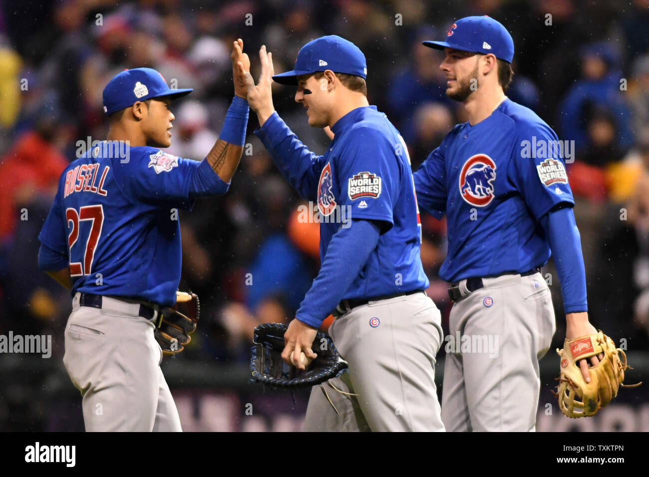Chicago Cubs' Addison Russell (L) Anthony Rizzo and Kris Bryant (R)  celebrate a 5-1 win over the Cleveland Indians after game 2 of the World  Series at Progressive Field in Cleveland, Ohio