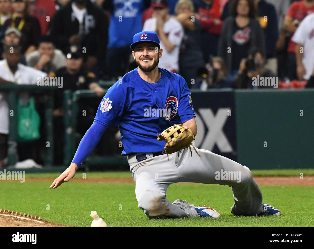 Chicago Cubs Kris Bryant falls to the ground after throwing to