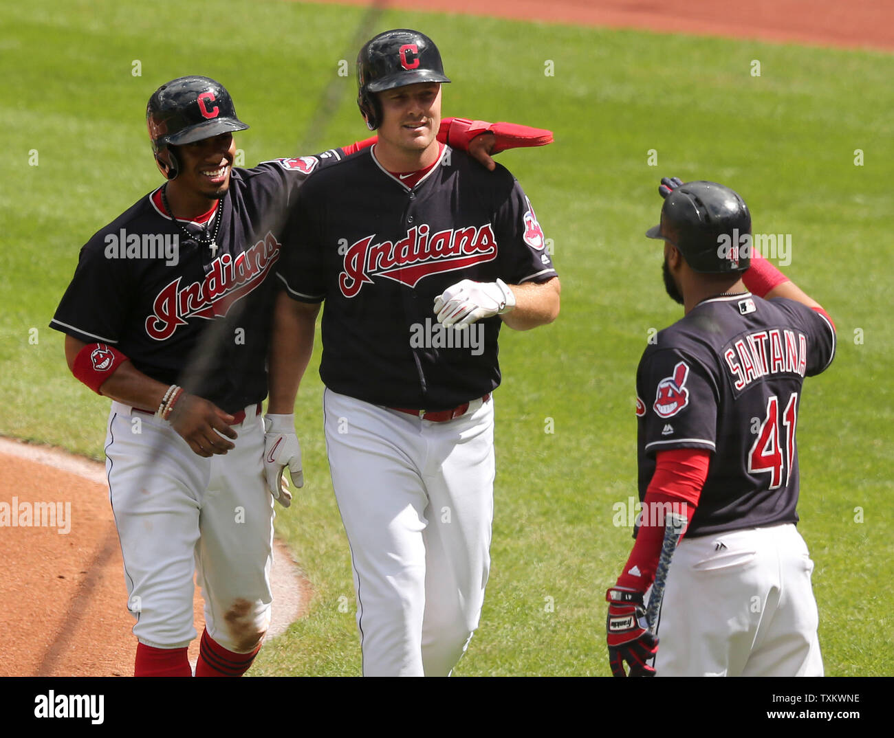Cleveland Indians Jay Bruce (M) is congratulated by Francisco Lindor (L) and Carlos Santana (R) after hitting a three run home run in the first inning of a game against the Detroit Tigers at Progressive Field in Cleveland, Ohio on September 13, 2017. Photo by Aaron Josefczyk/UPI Stock Photo