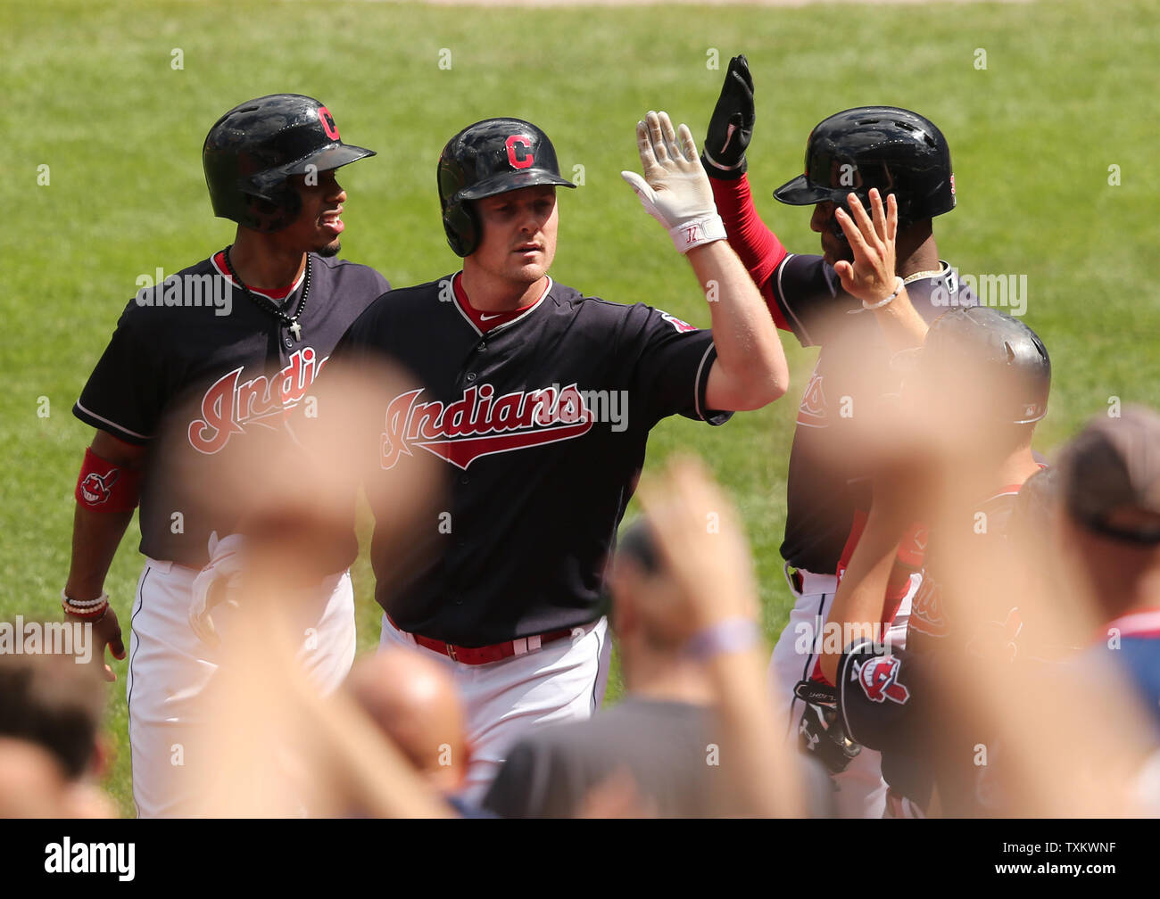 Cleveland Indians Jay Bruce (M) is congratulated by Francisco Lindor (L) and Carlos Santana (R) after hitting a three run home run in the first inning of a game against the Detroit Tigers at Progressive Field in Cleveland, Ohio on September 13, 2017. Photo by Aaron Josefczyk/UPI Stock Photo