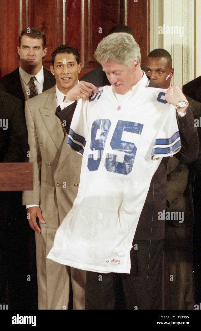 U.S. President Bill Clinton holds his Dallas Cowboys jersey, present to ...