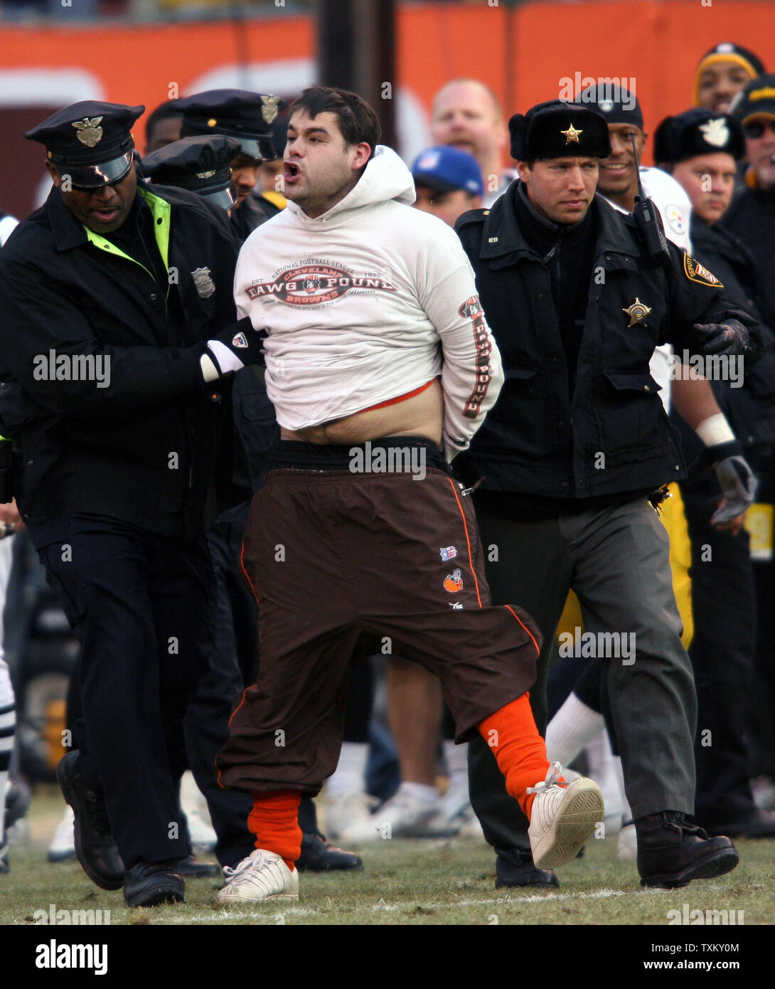 A Cleveland Browns fan is yells out as he is escorted by police from the  field after he lept from the stands and ran across the field in the fourth  quarter of