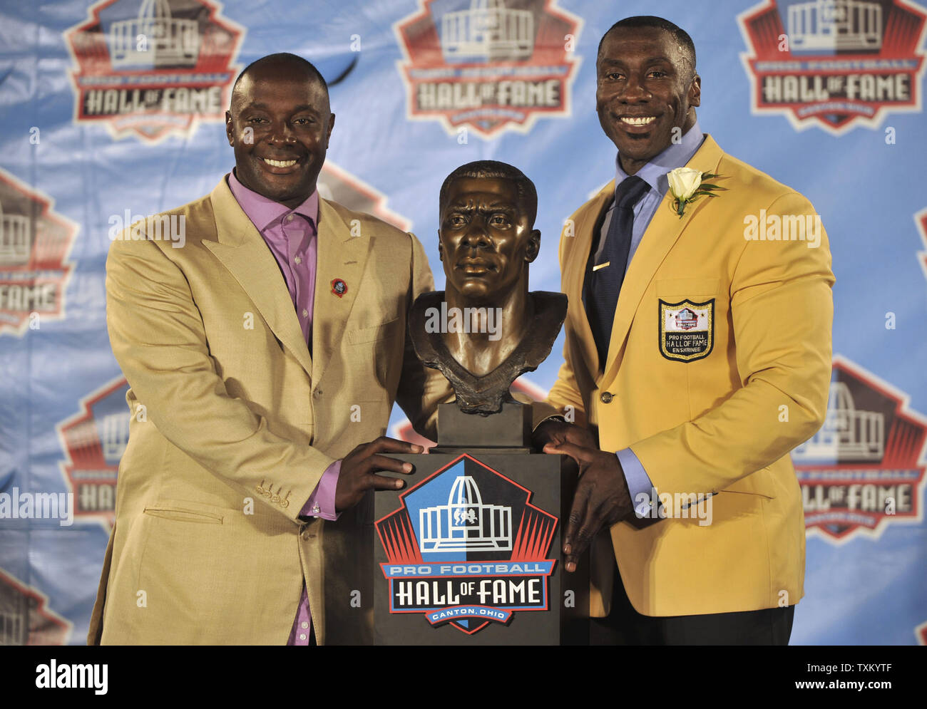 Shannon Sharpe, right, and his brother and presenter Sterling Sharpe pose with Shannon's bronze bust during the Pro Football Hall of Fame Enshrinement Ceremonies at Fawcett Stadium in Canton, Ohio, on August 6, 2011. Shannon Sharpe was inducted with the 2011 class. UPI / David Richard Stock Photo
