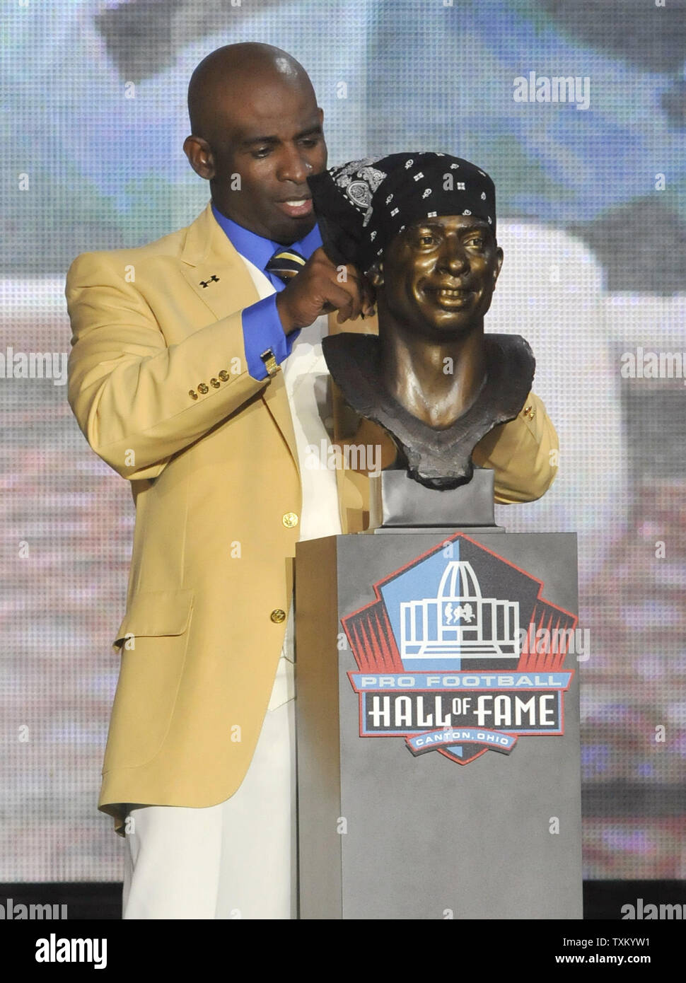 Deion Sanders puts a bandana on a bust of himself during the induction  ceremony at the Pro Football Hall of Fame, Saturday, Aug. 6, 2011, in  Canton, Ohio. (AP Photo/Ron Schwane Stock