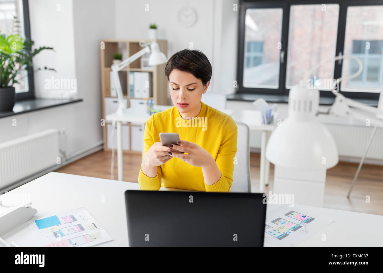 ui designer using smartphone at office Stock Photo