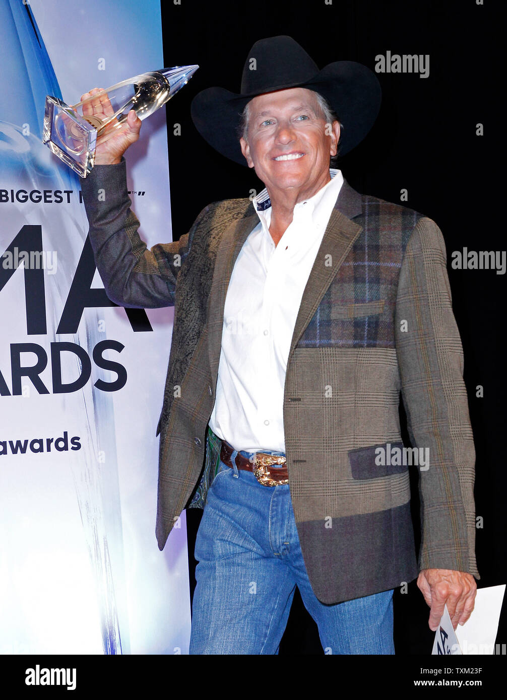 Entertainer of the Year George Strait poses backstage with his trophy at the 47th Annual Country Music Awards at the Bridgestone Arena in Nashville, November 6, 2013. UPI/Terry Wyatt Stock Photo