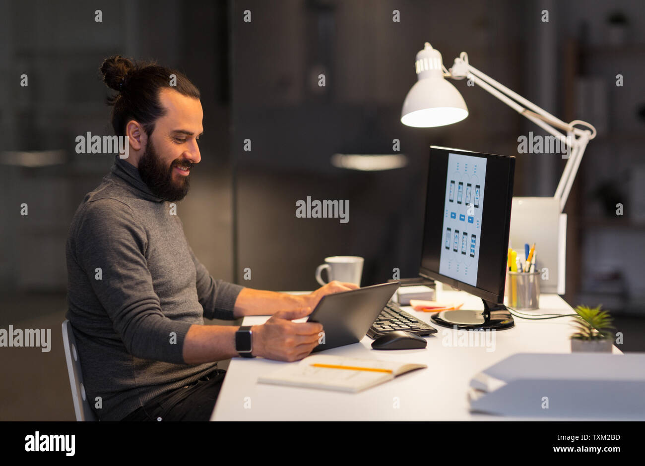 creative man with computer working at night office Stock Photo - Alamy