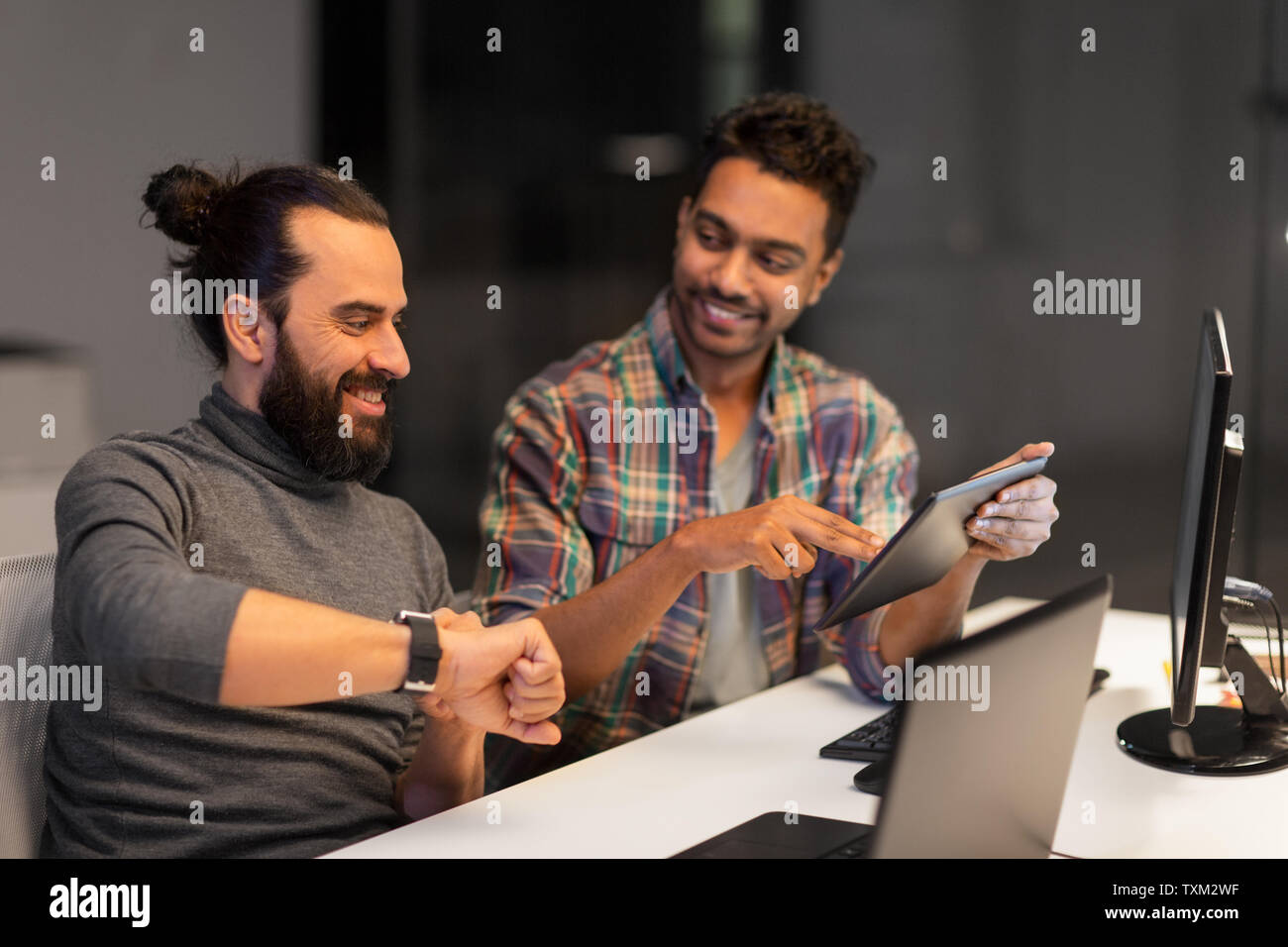 creative team with tablet pc works at night office Stock Photo