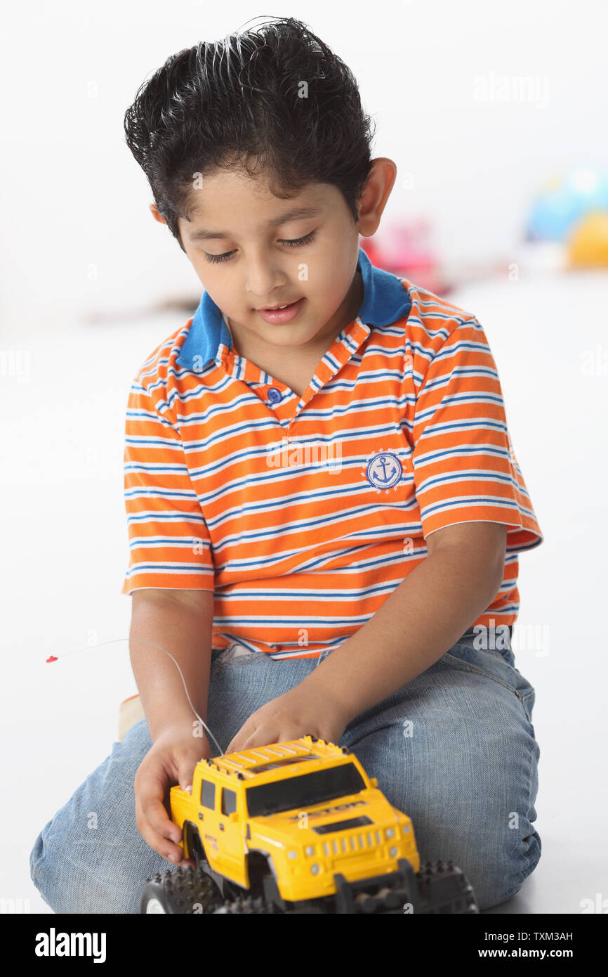 Boy playing with a toy car Stock Photo - Alamy
