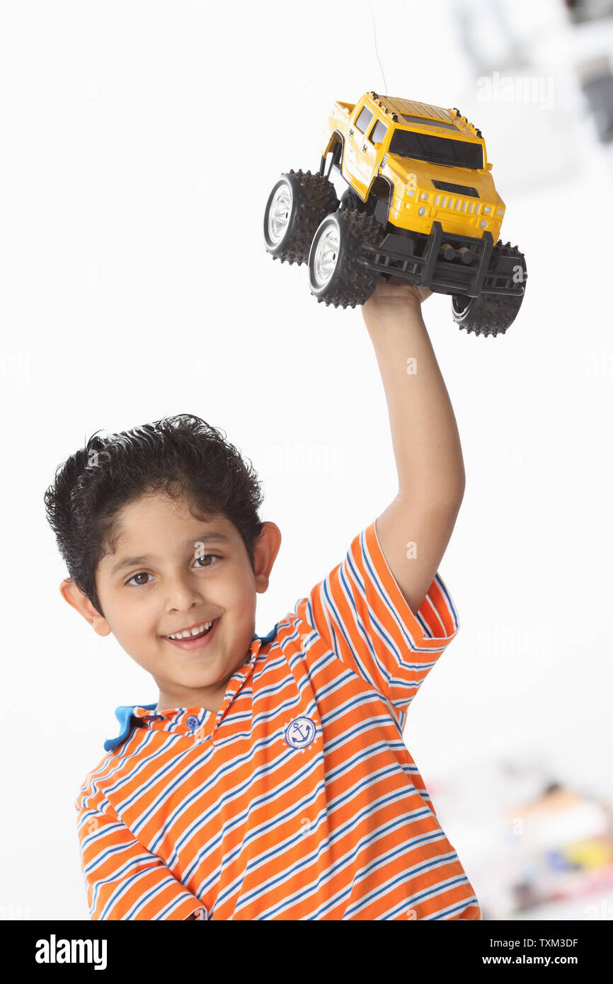 Boy playing with a toy car Stock Photo - Alamy