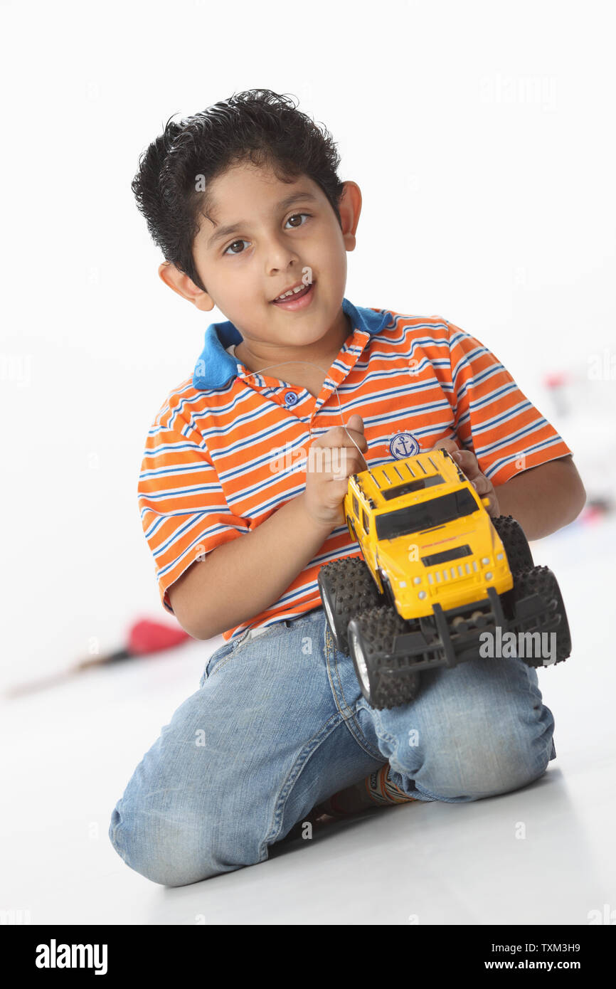 Boy playing with a toy car Stock Photo - Alamy