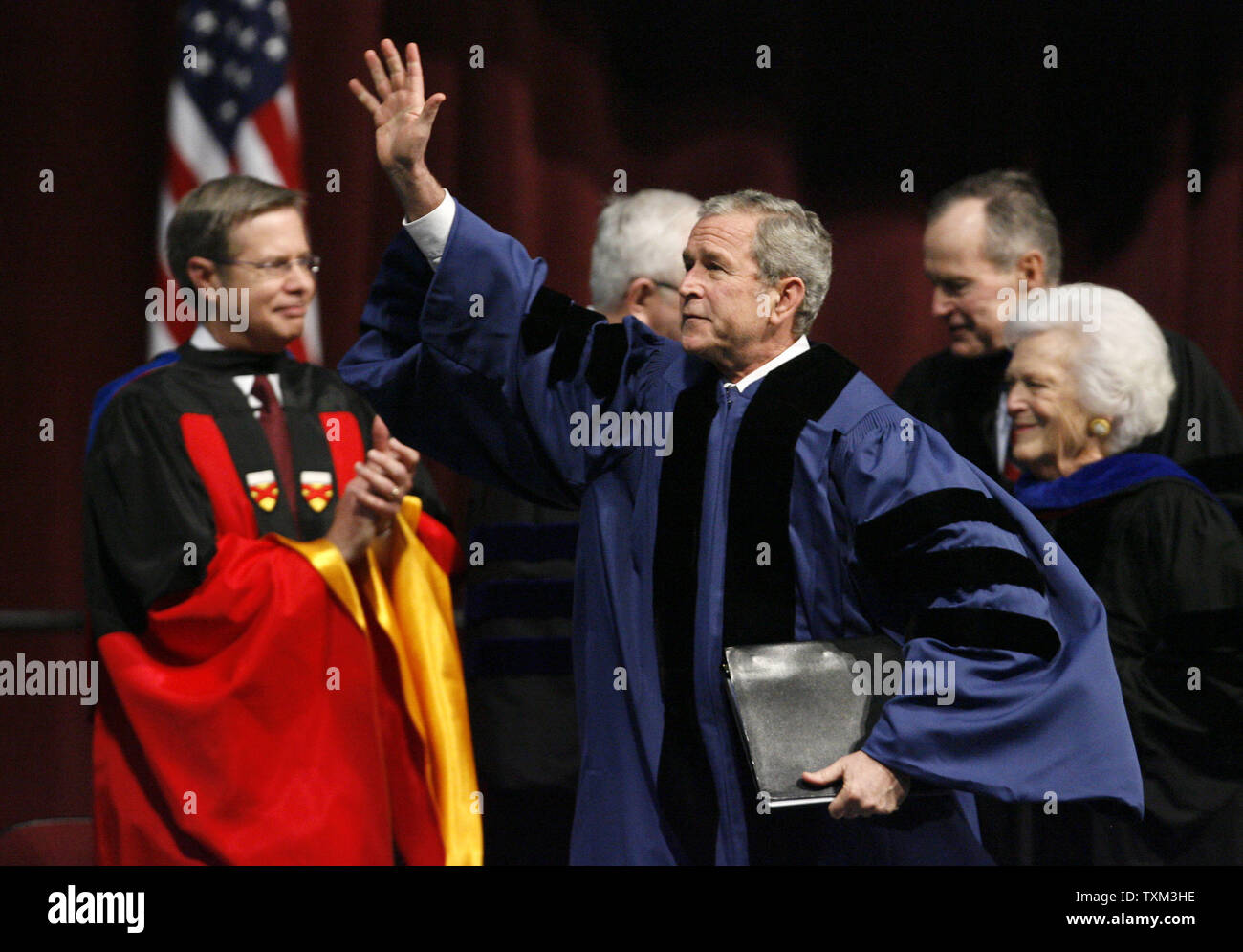 U.S. President George W. Bush waves to the crowd as he leaves the stage ...