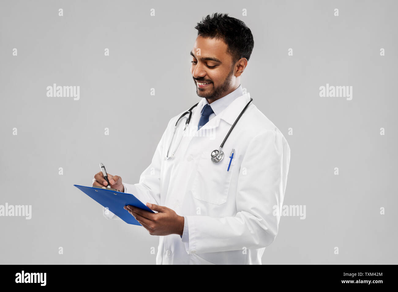 indian male doctor with clipboard and stethoscope Stock Photo - Alamy