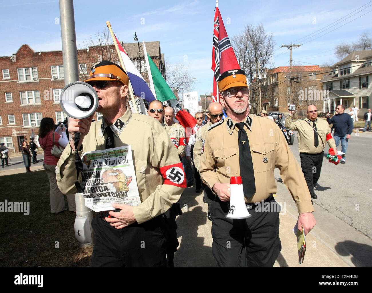 Members of the National Socialist Movement march on the campus of the University of Missouri in Columbia, Missouri on March 10, 2007. About 20 marchers were met by throngs of students that cursed them and tossed eggs into their march. (UPI Photo/Bill Greenblatt) Stock Photo