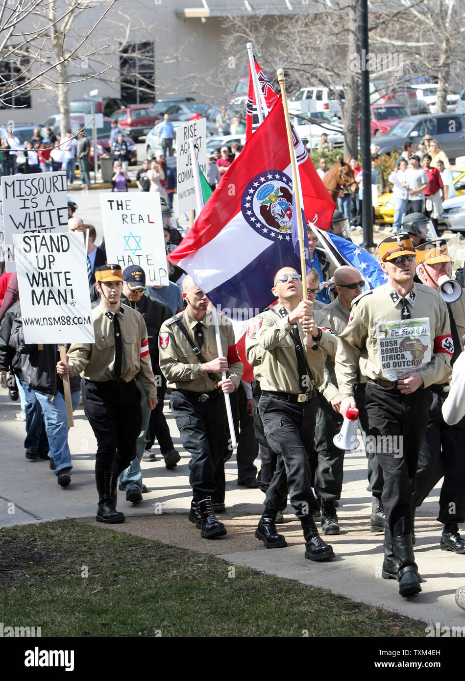 Members of the National Socialist Movement march on the campus of the University of Missouri in Columbia, Missouri on March 10, 2007. About 20 marchers were met by throngs of students that cursed them and tossed eggs into their march. (UPI Photo/Bill Greenblatt) Stock Photo