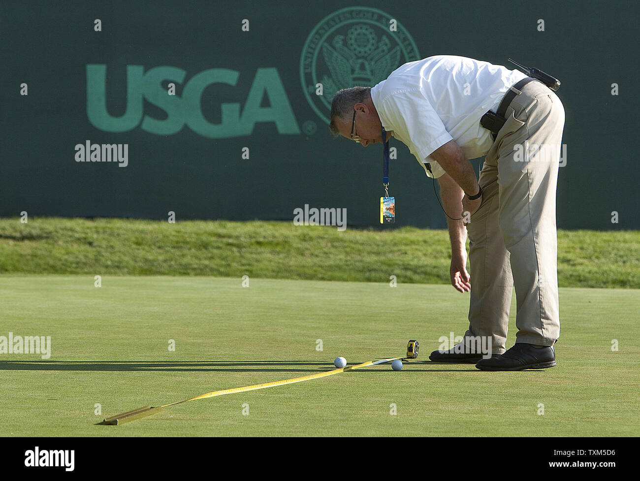 A United States Golf Association official tests the speed of the 18th green before play begins for the first round of the U.S. Women's Open at the Broadmoor East Course in Colorado Springs on July 7, 2011.       UPI/Gary C. Caskey Stock Photo