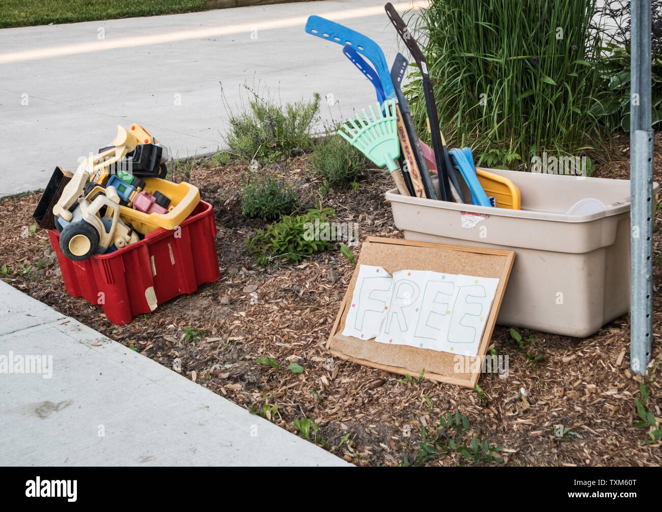 Two plastic recycling bins full of plastic toys Stock Photo Alamy