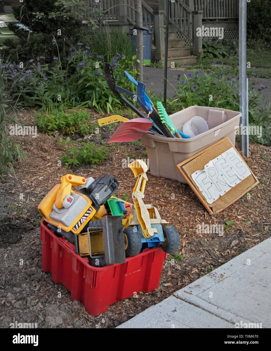 Two plastic recycling bins full of plastic toys Stock Photo Alamy