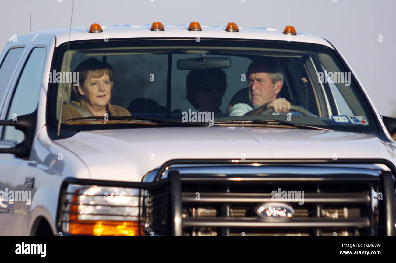 U.S. President George W. Bush (R) drives with German Chancellor Angela Merkel (L) and First Lady Laura Bush (C) at Bush's ranch in Crawford, Texas on November 9, 2007.  (UPI Photo/Ron Russek II) Stock Photo