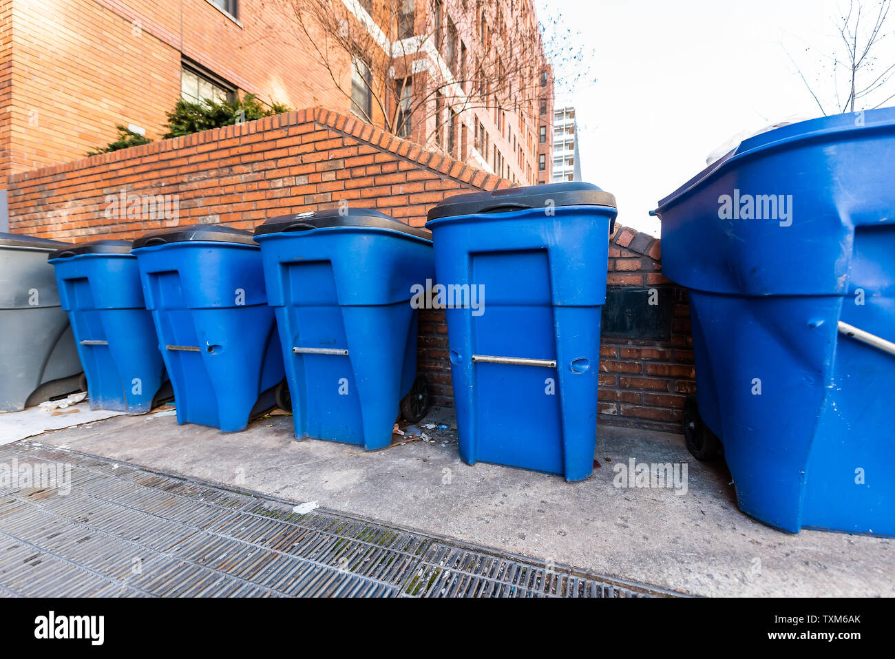 Washington DC, USA blue trash bins by residential apartment building in