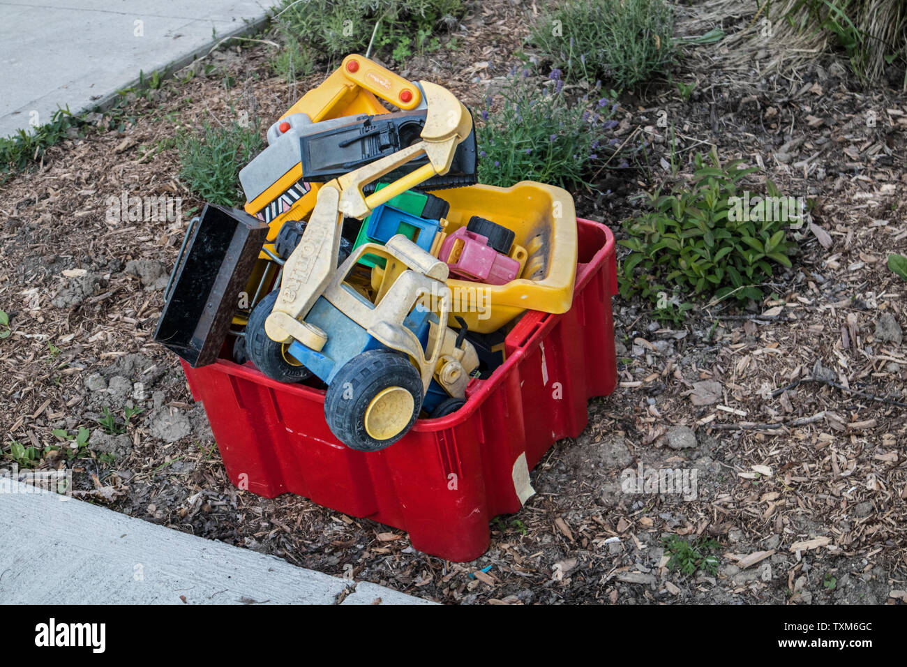 Two plastic recycling bins full of plastic toys Stock Photo Alamy