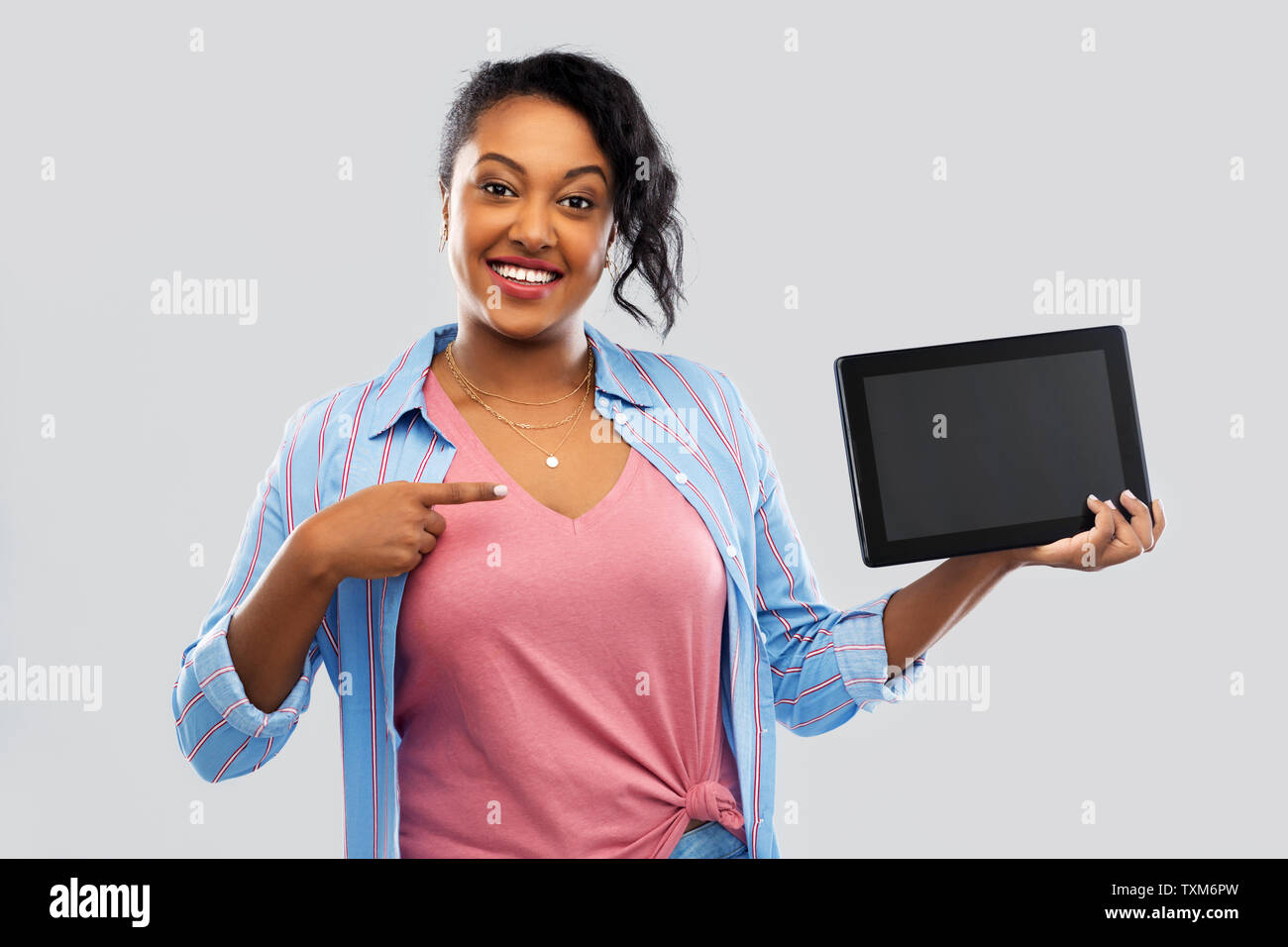 happy african american woman showing tablet pc Stock Photo - Alamy